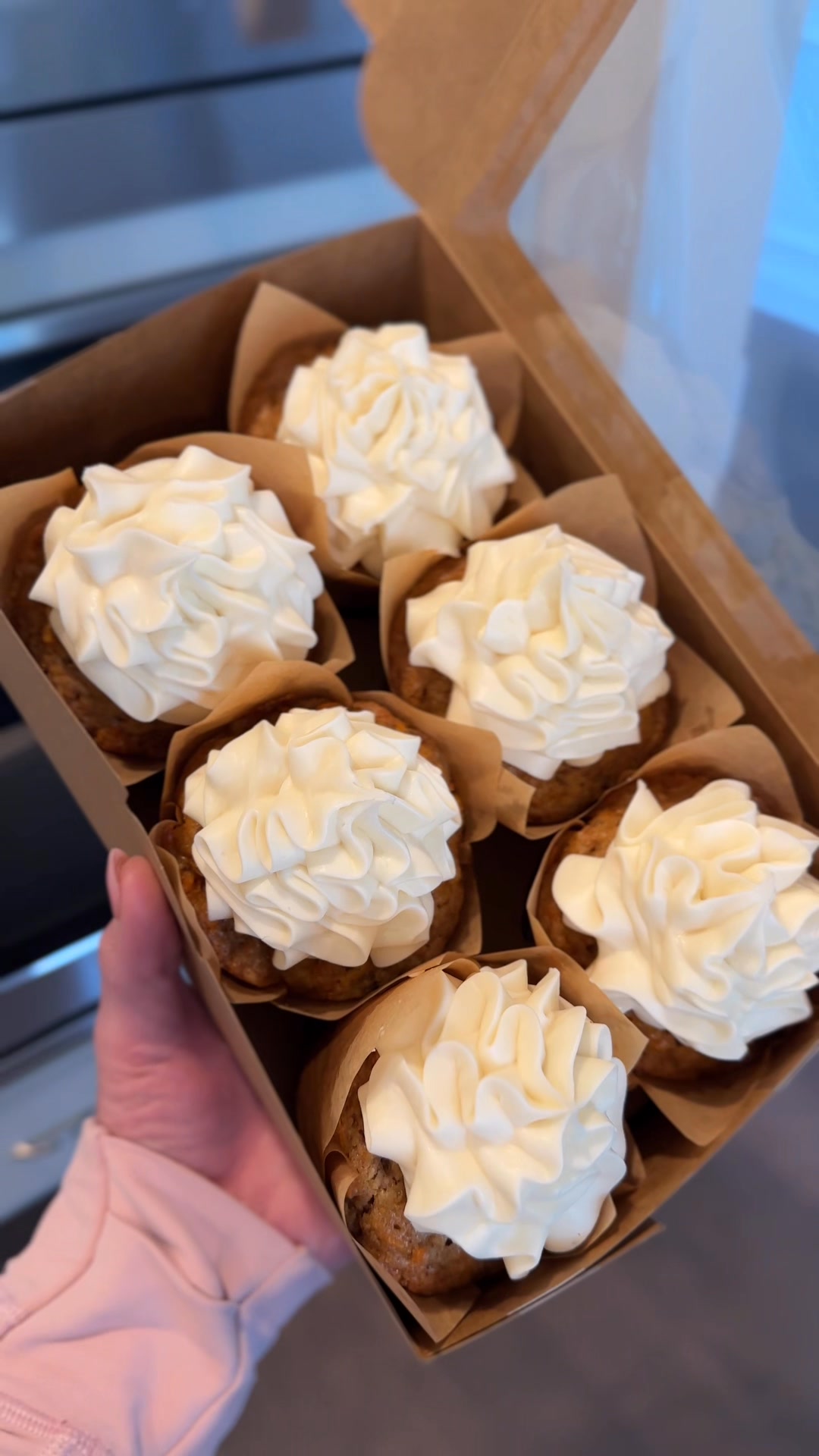 Box of freshly iced carrot cake cupcakes
